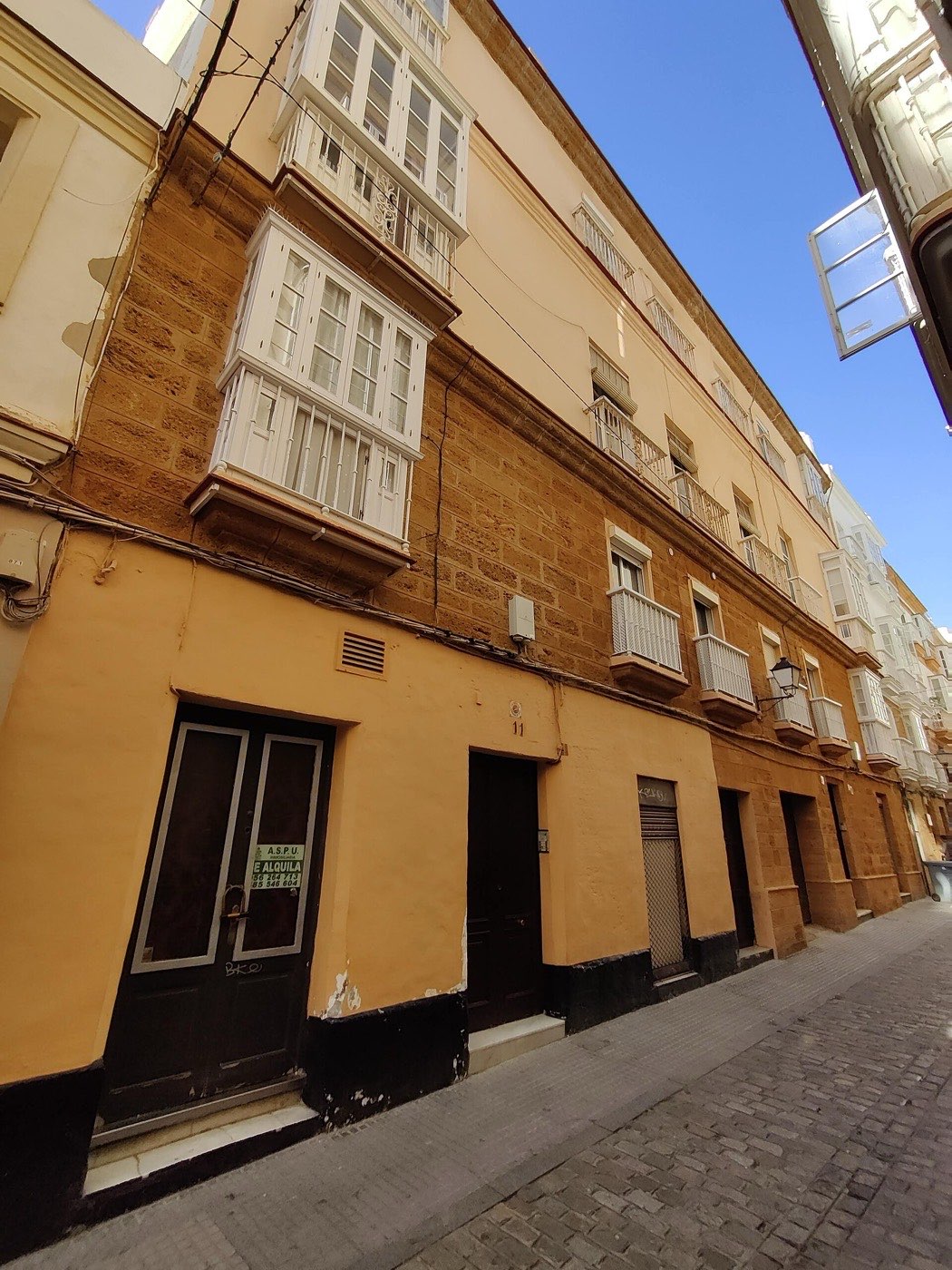 Front of an apartment building with white glazed balconies on Calle Rosario, Cádiz